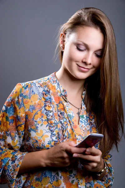 Portrait of a young beautiful girl in a bright colored blouse lo — Stock Photo, Image