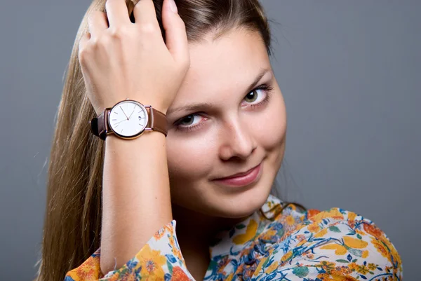 Close-up portrait of young beautiful girl with a wristwatch Stock Image