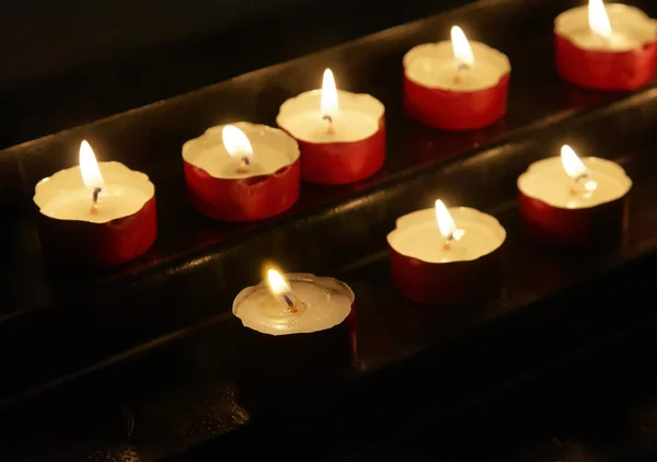 Votive candles in church — Stock Photo, Image