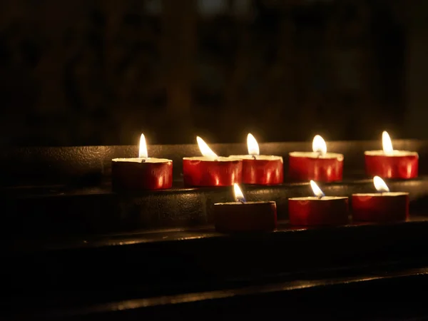 Votive candles in church — Stock Photo, Image