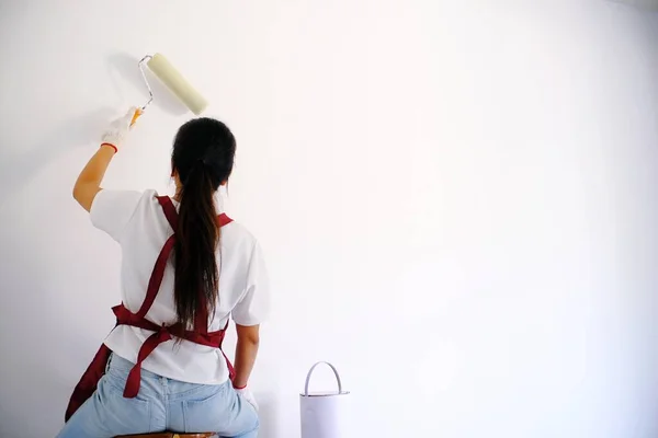 Asian woman painter painting Job in room