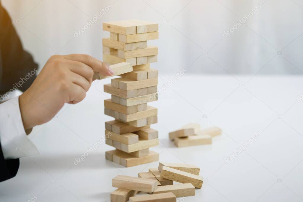 Planning risk and strategy in businessman gambling placing wooden block.Business concept for growth success process.