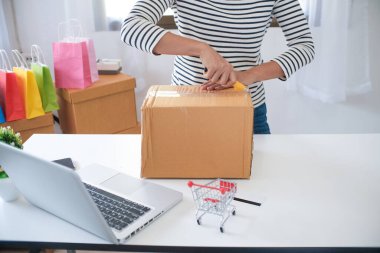 Kadın evde paket teslimat kutusu hazırlıyor online sipariş alışverişi