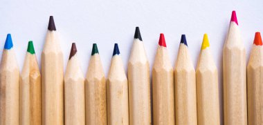 Beyaz kağıt arka planda renkli kalemler. Boşluğu kopyala