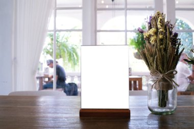 Bar restoranının kafesinde ahşap masada duran menü çerçevesi. Metin pazarlama promosyonu için boşluk