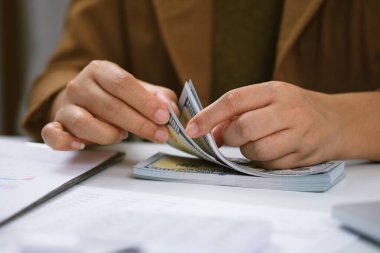 Yatırım çizelgelerini analiz eden ve belgelerin üzerindeki hesap makinesi tuşlarına basan bir işadamı. Muhasebe Kavramı