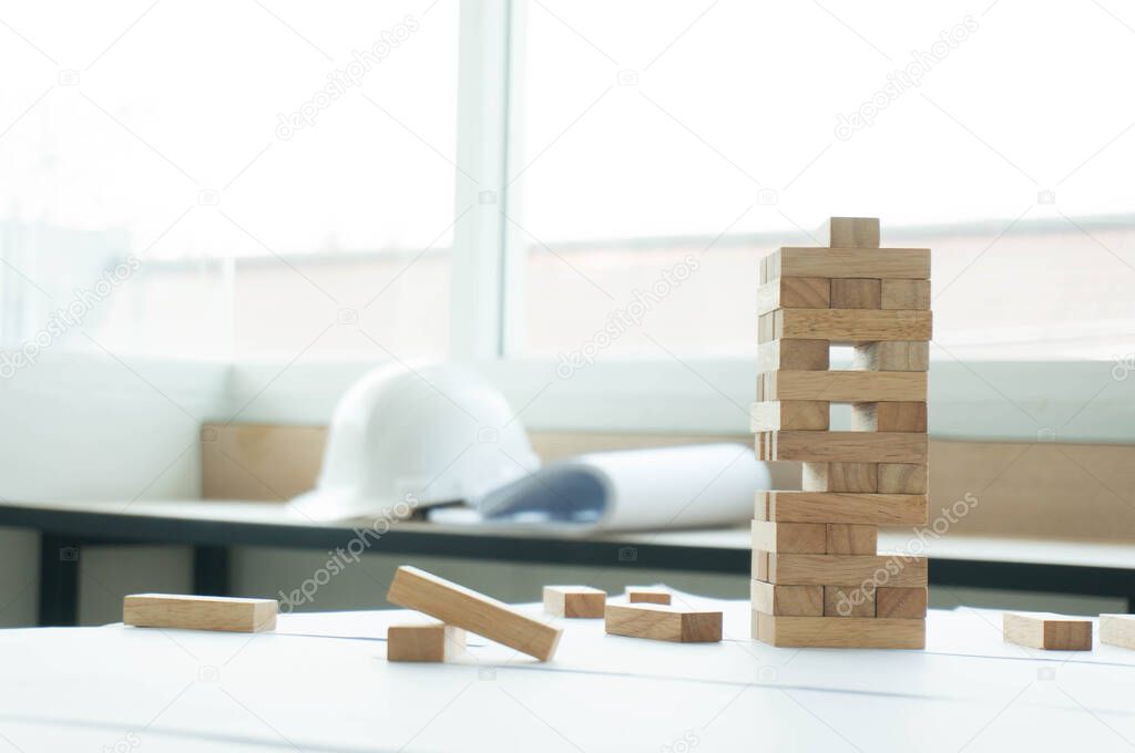 Business risk concept with wood jenga game.Businessman manage his strategy.