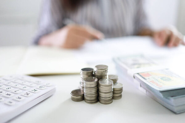 Saving money concept Financial woman hand stack coins money banknotes  growing business. cash money in dollar banknotes
