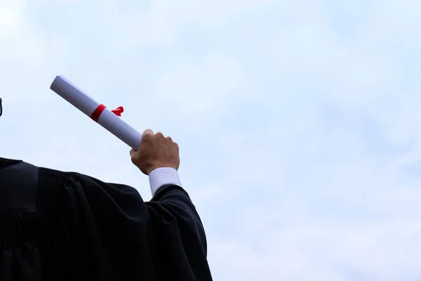 Student with congratulations, graduates wearing a graduation gown of university