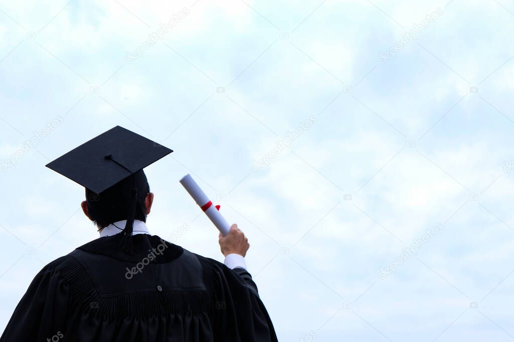 Student with congratulations, graduates wearing a graduation gown of university