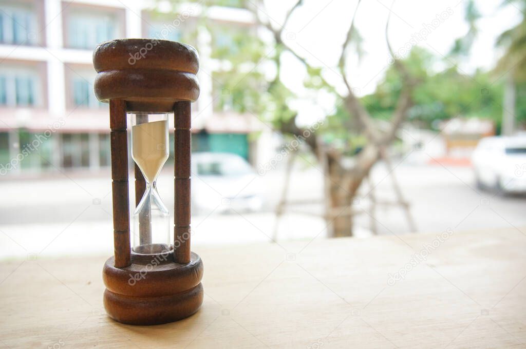 Hourglass. Sand running through the bulbs of hourglass passing time countdown to deadline