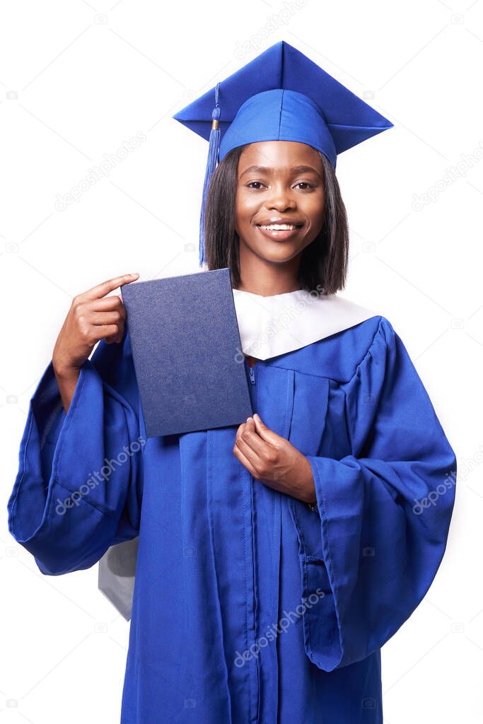 African-American beautiful woman in a blue robe and hat, on a white isolated background smiles and shows diploma
