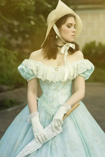 Une belle jeune femme dans une robe bleue historique 1860 année. Conception de couverture de livre. — Photo