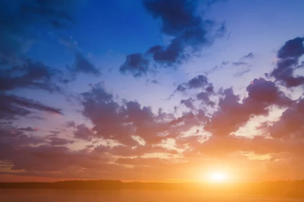 Blue-orange pastel sky in the background. Beautiful romantic dreamy clouds. At sunset