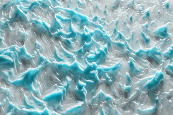 La textura cosmética de la crema azul. Primer plano. Líneas azules dinámicas —  Fotos de Stock