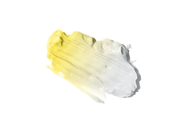 Krämens utstryk och konsistens. Gul-vit färg, isolerad på en vit bakgrund. Ett element för kosmetisk skönhetsdesign. — Stockfoto