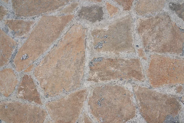 Superficie de camino de piedra vieja naranja. Textura sin costuras. La textura de un camino de piedra —  Fotos de Stock