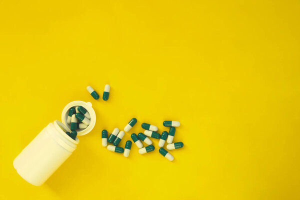 Epidemic disease,On the table are pills and a thermometer on a yellow background
