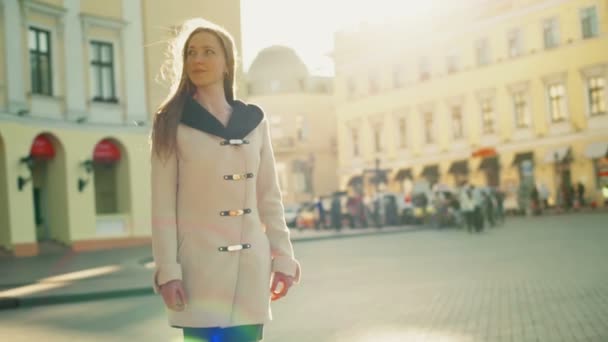 Mosolyogva, hogy női nézett körül a régi town square lassú mozgás — Stock videók