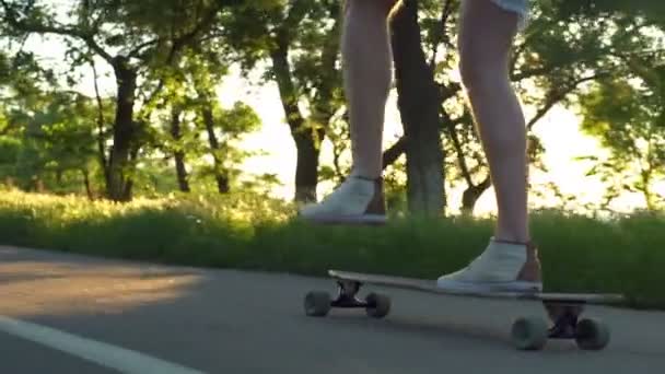 Mężczyzna nogi jazda longboard w słońcu światło zwolnionym tempie z bliska — Wideo stockowe