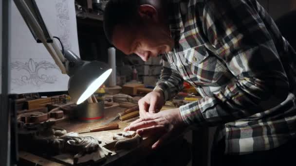 Young adult male working with wood frame in his own workshop — Stock Video