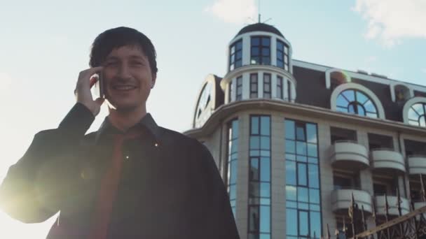 Uomo sorridente in camicia e cravatta parlare al telefono in strada rallentatore — Video Stock