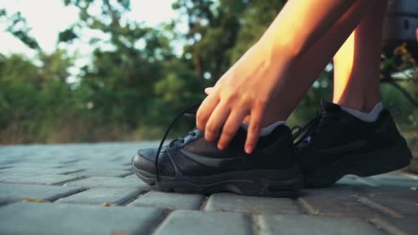 Бегунья завязывает шнурки на шнурках замедленной съемки — стоковое видео