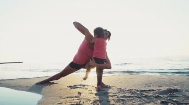 Anne çocuğunu üzerinde plaj yavaş hareket ile streitching yok