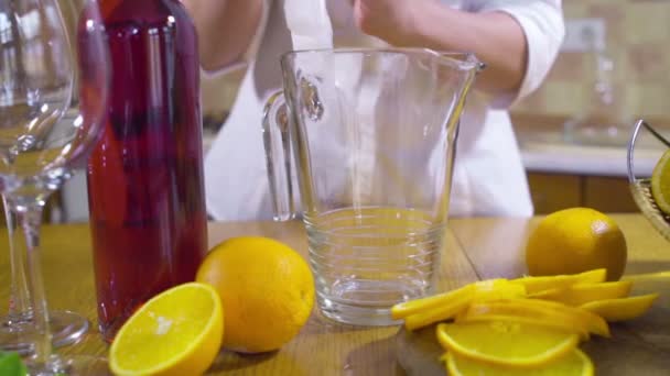 Woman pouring ice into a pitcher slow motion — Stock Video