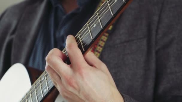 Close-up mannenhand nemen akkoorden op akoestische gitaar slow motion — Stockvideo