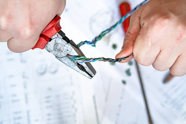 Various electrical tools and wires on a paper diagram, composition about home electrics