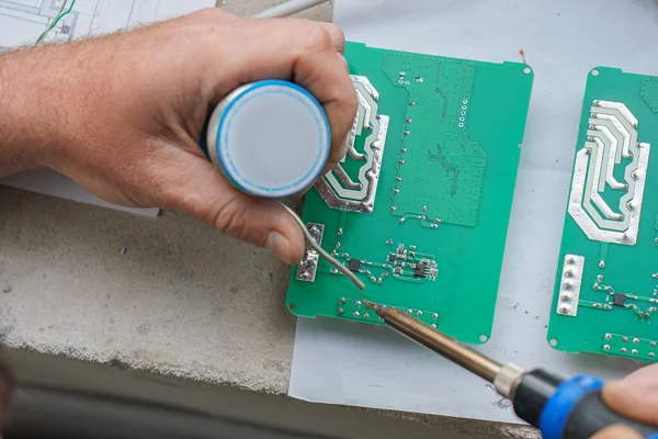 Electronic lab working place with soldering iron and circuit board