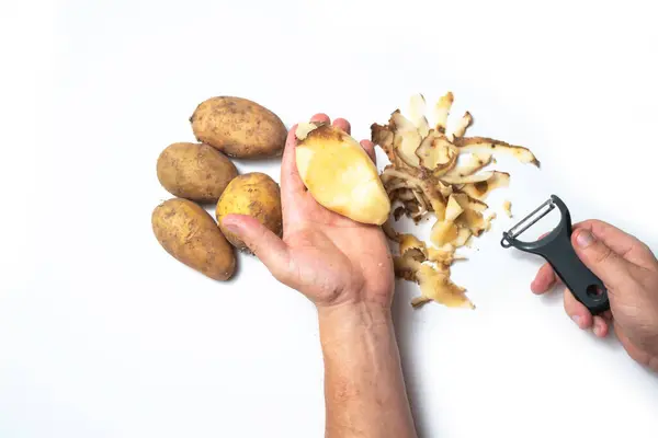Guy Peels Potatoes White Background Next Lies Potatoes Peel — Stock Photo, Image