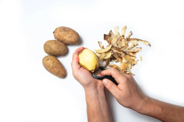 Guy Peels Potatoes White Background Next Lies Potatoes Peel — Stock Photo, Image