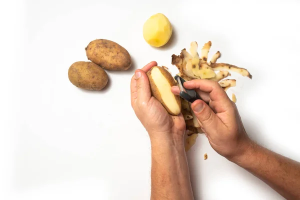 Guy Peels Potatoes White Background Next Lies Potatoes Peel — Stock Photo, Image