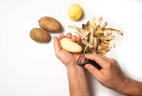 Guy Peels Potatoes White Background Next Lies Potatoes Peel — Stock Photo, Image