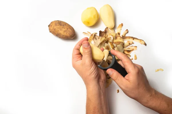 Guy Peels Potatoes White Background Next Lies Potatoes Peel — Stock Photo, Image