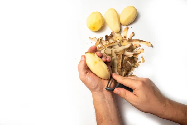 Guy Peels Potatoes White Background Next Lies Potatoes Peel — Stock Photo, Image