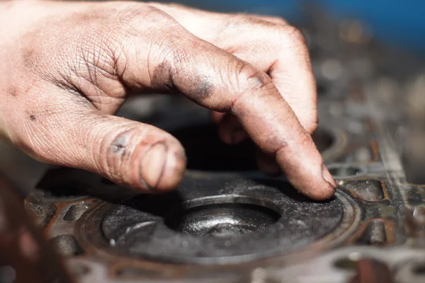 Mechanic hands tighten nut with wrench while repairing engine — Stock Photo, Image