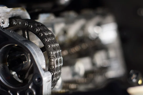 Mechanic hands tighten nut with wrench while repairing engine