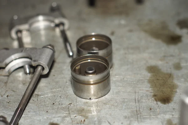 Mechanic hands tighten nut with wrench while repairing engine