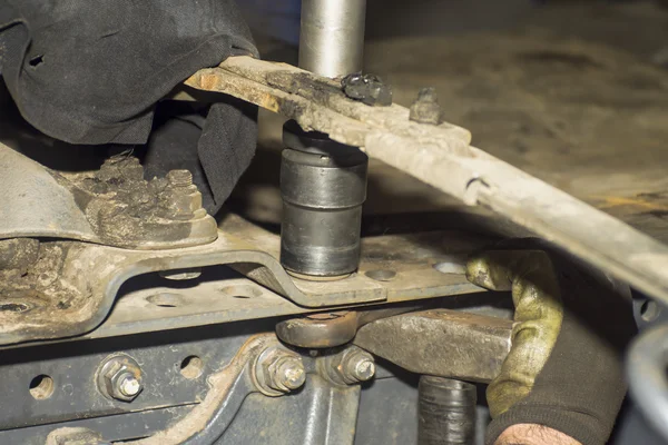 Dirty car mechanic hands examining car automobile at repair service station