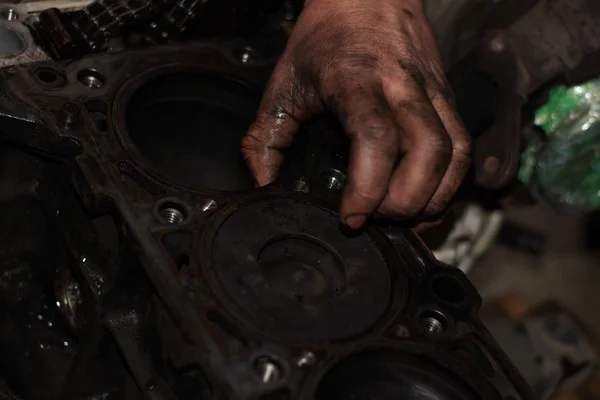 Mechanic hands tighten nut with wrench while repairing engine — Stock Photo, Image