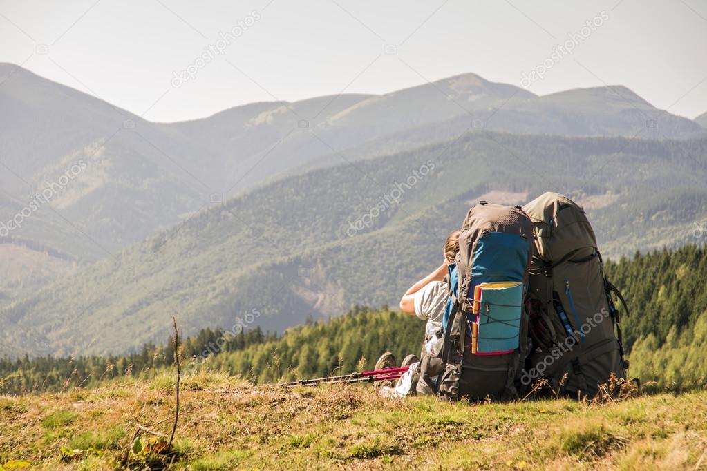 Two tourists enjoy the scenery on top of  mountain