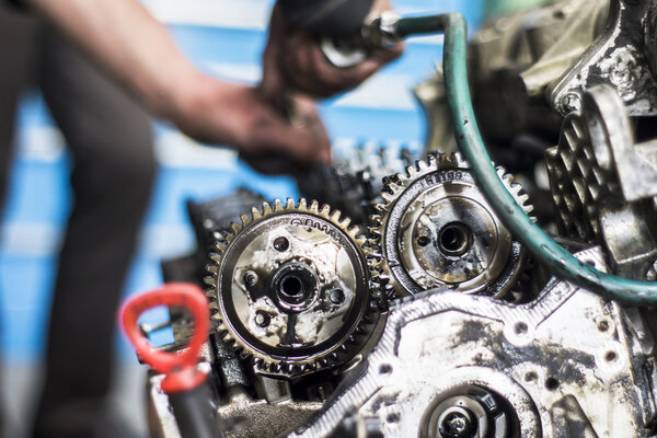 Mechanic working with with engine in a workshop