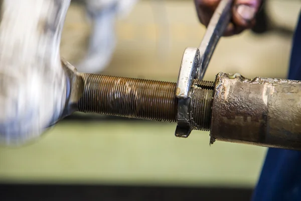 Mechanic wrench spun the old nut — Stock Photo, Image