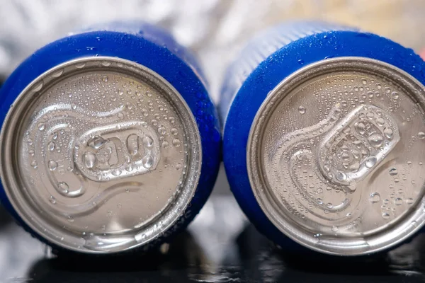 cans with soda Condensate, water drops on two cans with a drink