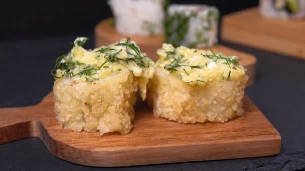 Pães assados e sushi em um restaurante chinês ou japonês. pauzinhos de madeira — Vídeo de Stock