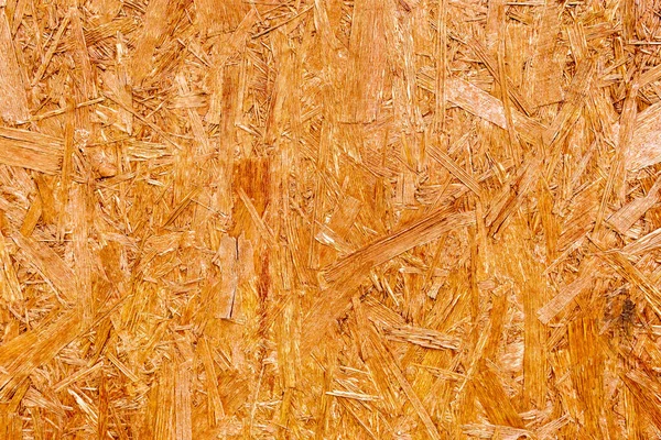 Wooden background.Textured wooden background made of pressed wood shavings of natural color.