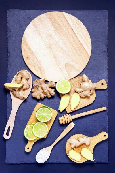 concept of healthy eating. fruits root of ginger, slices lime, honey, with copy space. vertical photo